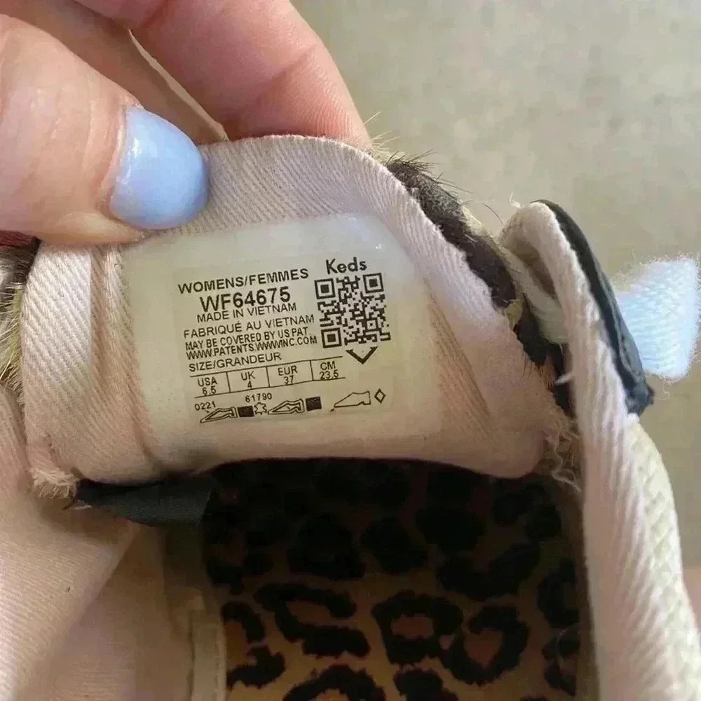 Keds beige canvas sneakers with black trim and leopard heel